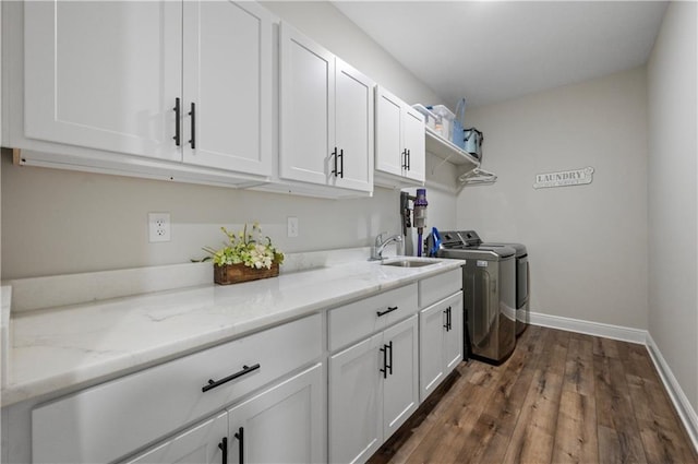 washroom featuring cabinets, independent washer and dryer, dark hardwood / wood-style floors, and sink