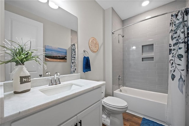 full bathroom with hardwood / wood-style flooring, vanity, toilet, and shower / bath combo with shower curtain