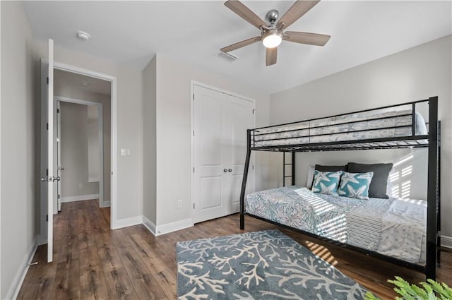 bedroom featuring hardwood / wood-style flooring, ceiling fan, and a closet