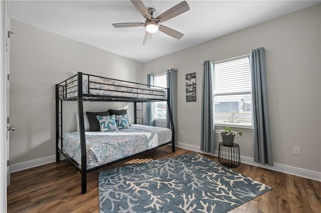 bedroom with dark hardwood / wood-style floors and ceiling fan