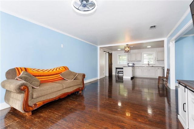 208 Beck St, Atmore, AL 36502 - living area featuring dark wood-type flooring and crown molding