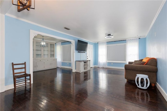 208 Beck St, Atmore, AL 36502 - living area with ornamental molding, wood finished floors, and a chandelier