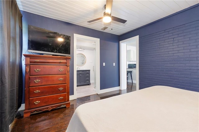 208 Beck St, Atmore, AL 36502 - bedroom featuring dark wood-style flooring, brick wall, ceiling fan, and ensuite bathroom