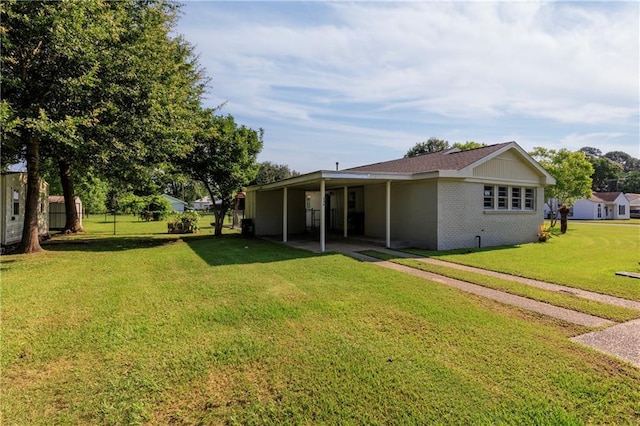 208 Beck St, Atmore, AL 36502 - rear view of property with a yard, brick siding, and a patio area