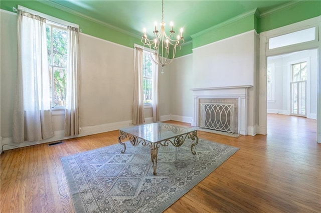 1703 Dauphin St, Mobile, AL 36604 - living room with a chandelier, plenty of natural light, wood finished floors, and crown molding