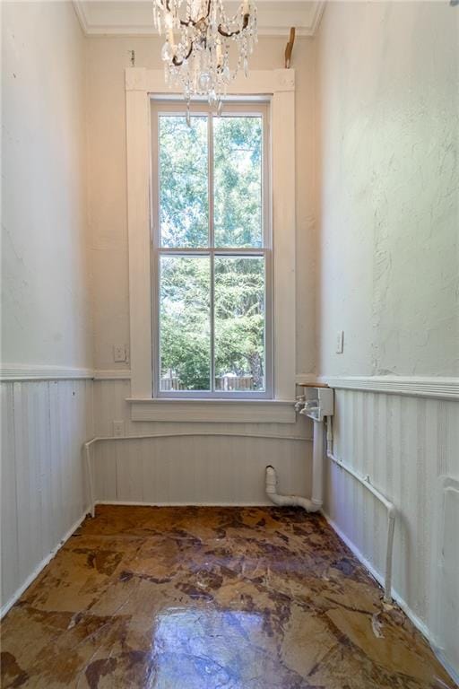1703 Dauphin St, Mobile, AL 36604 - spare room featuring a chandelier, healthy amount of natural light, crown molding, and wainscoting