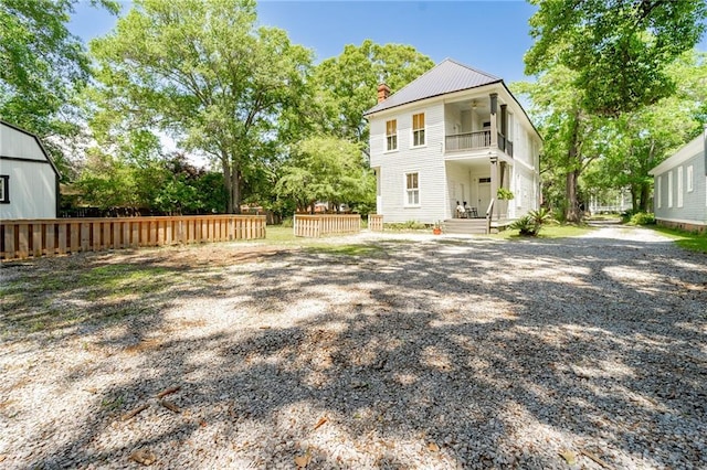 1703 Dauphin St, Mobile, AL 36604 - rear view of property featuring a balcony, ceiling fan, a chimney, and metal roof