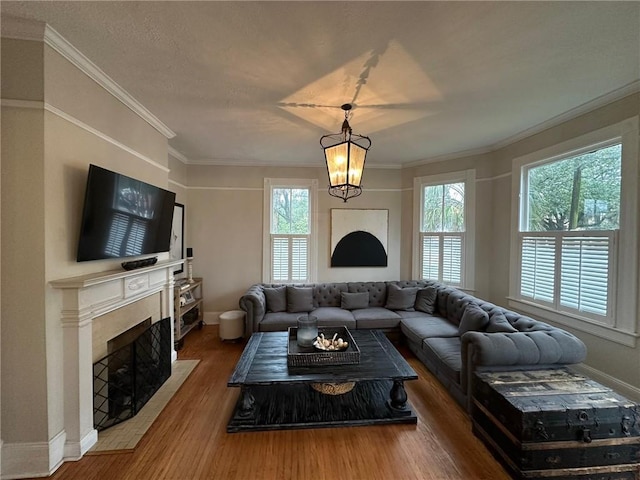 1703 Dauphin St, Mobile, AL 36604 - living area featuring a fireplace with flush hearth, wood finished floors, baseboards, and crown molding