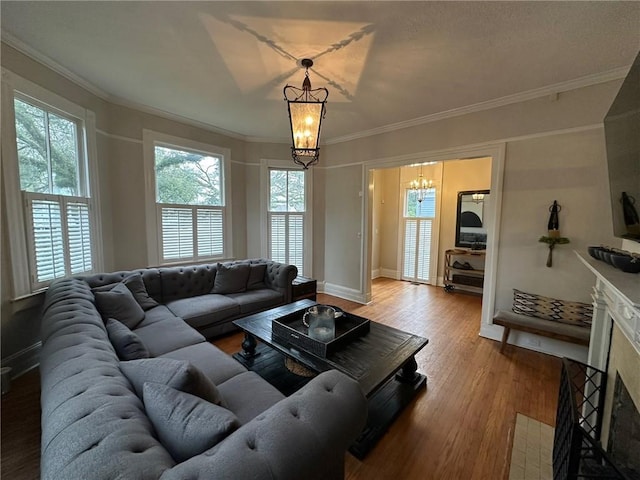 1703 Dauphin St, Mobile, AL 36604 - living area with a chandelier, wood finished floors, crown molding, and baseboards