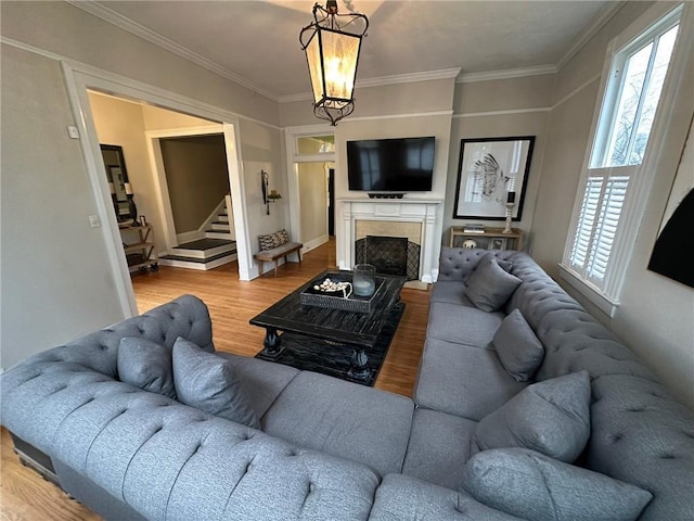 1703 Dauphin St, Mobile, AL 36604 - living room featuring wood finished floors, crown molding, stairs, a high end fireplace, and a chandelier