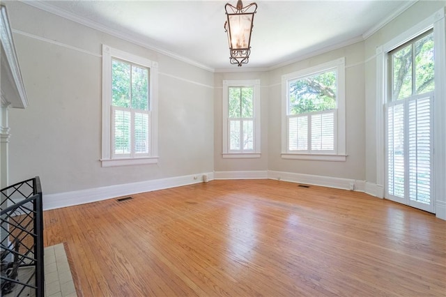 1703 Dauphin St, Mobile, AL 36604 - spare room featuring light wood-style flooring, baseboards, and ornamental molding