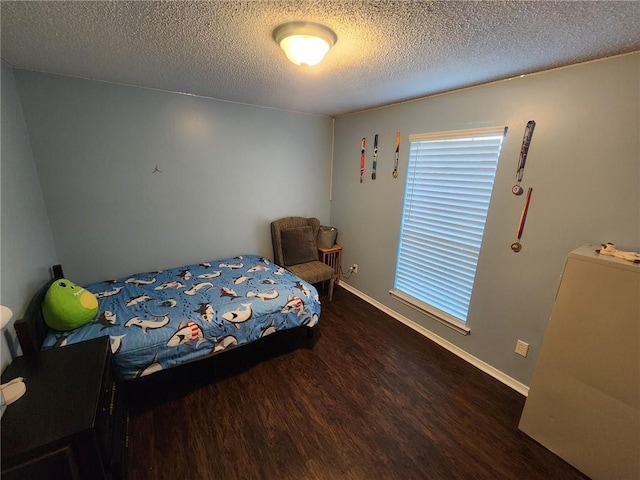 bedroom featuring dark wood-type flooring and a textured ceiling