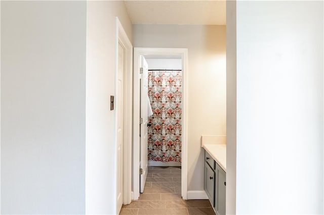 interior space with light tile patterned floors and baseboards