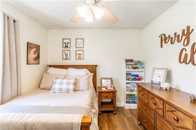 bedroom featuring a ceiling fan and dark wood finished floors