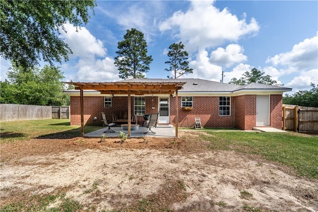 rear view of property with a patio, a fenced backyard, a pergola, and brick siding