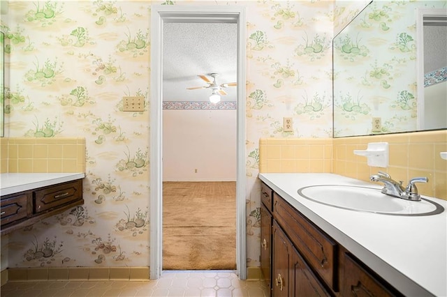 bathroom featuring vanity, a textured ceiling, and ceiling fan