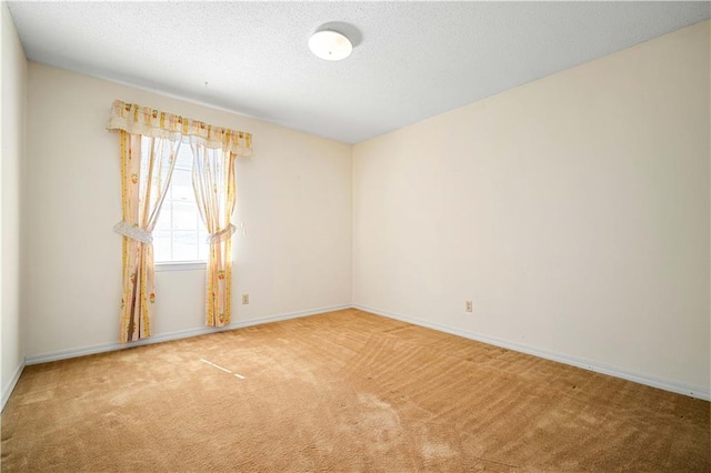 carpeted empty room with a textured ceiling