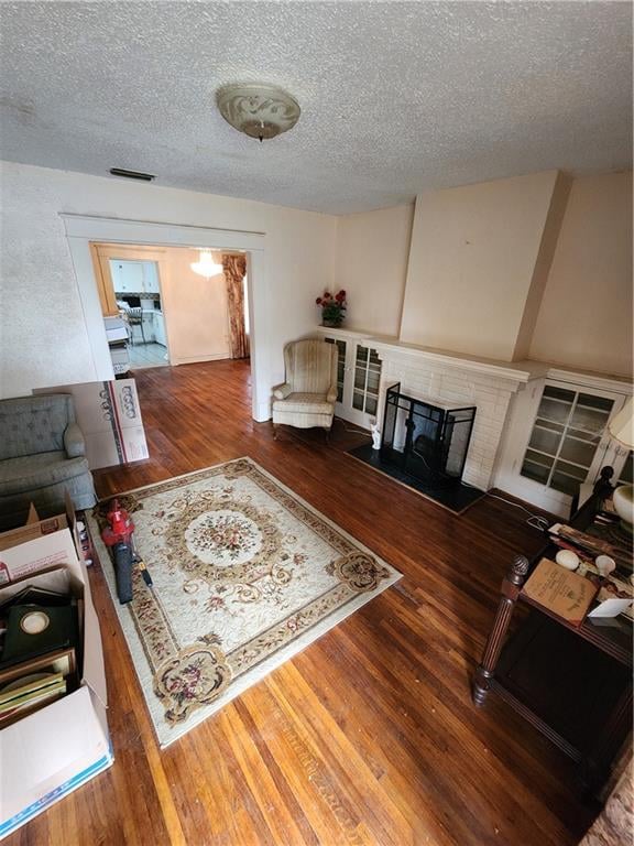 living room with hardwood / wood-style flooring and a textured ceiling