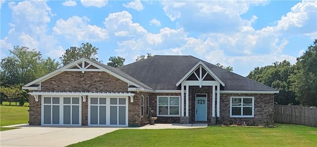 craftsman-style home featuring a garage and a front lawn