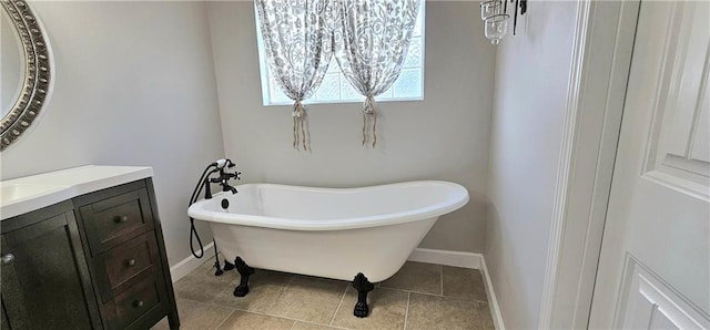 bathroom featuring tile patterned floors, a tub to relax in, and vanity