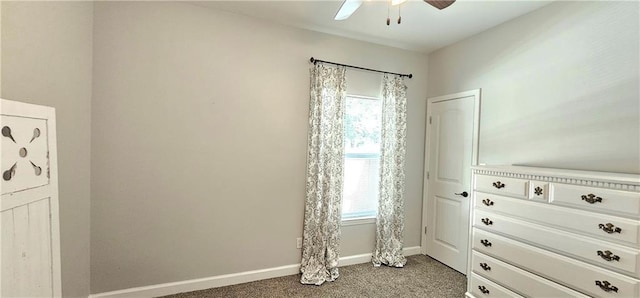 unfurnished bedroom with ceiling fan, multiple windows, and carpet flooring