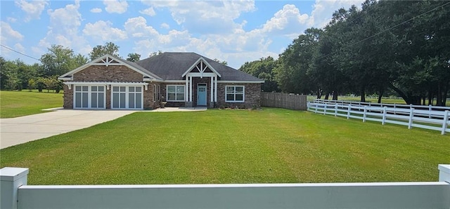 view of front of property featuring a garage and a front lawn