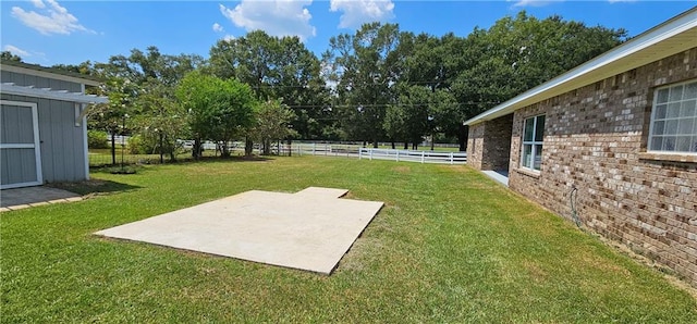 view of yard featuring a shed and a patio