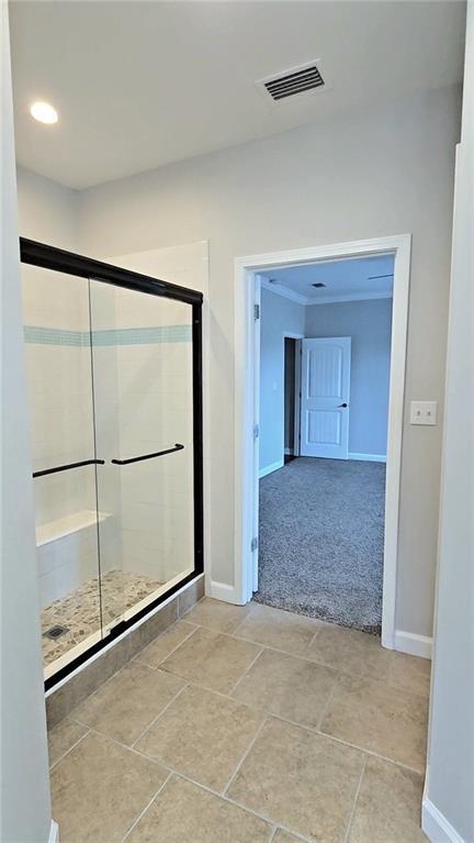 bathroom featuring an enclosed shower