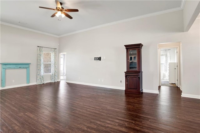 unfurnished living room featuring ceiling fan, dark wood-type flooring, ornamental molding, and a healthy amount of sunlight