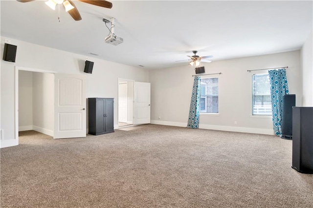 unfurnished living room with ceiling fan and light colored carpet