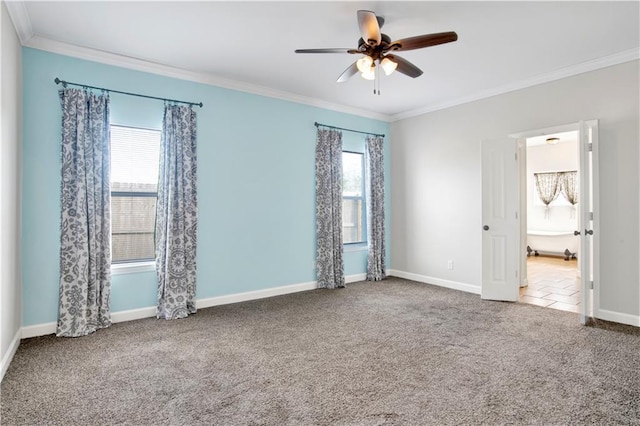 spare room featuring ceiling fan, carpet flooring, ornamental molding, and plenty of natural light