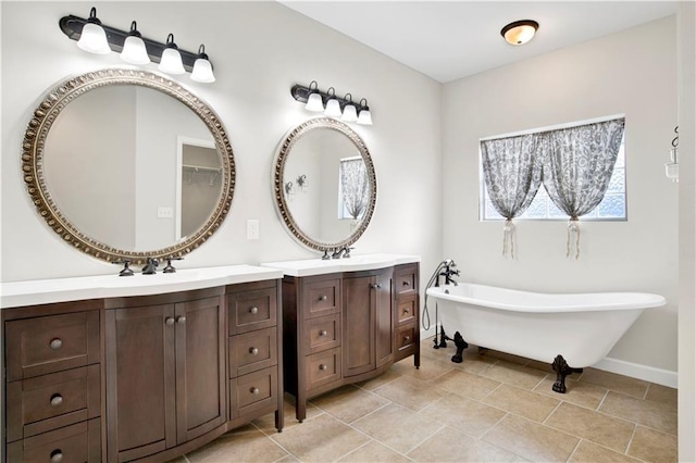 bathroom featuring tile patterned floors, a bathtub, and vanity