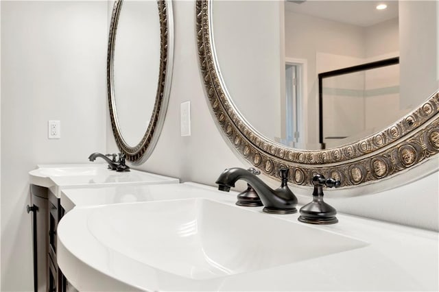 room details featuring a shower with shower door and vanity