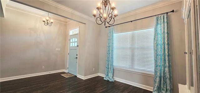 foyer featuring dark wood-type flooring, ornamental molding, and a notable chandelier