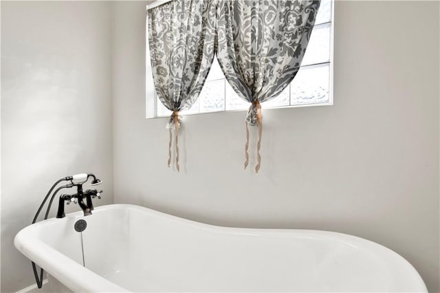 bathroom featuring a healthy amount of sunlight and a tub