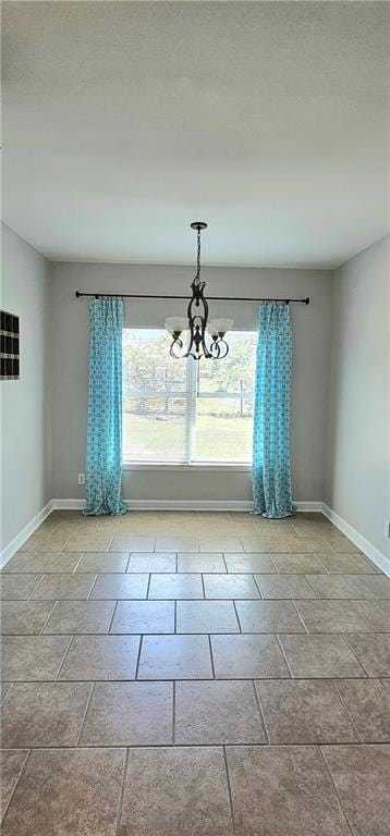 empty room featuring a chandelier