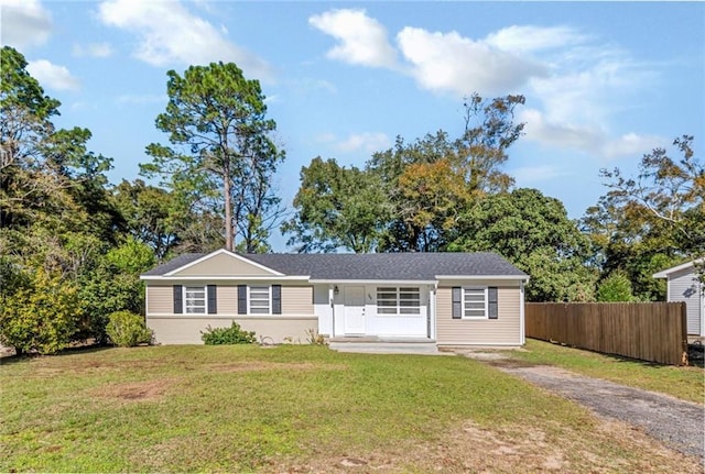 single story home with covered porch and a front yard