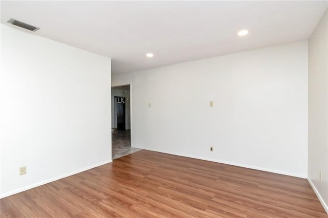 unfurnished room with hardwood / wood-style flooring