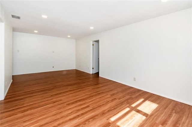 spare room with light hardwood / wood-style flooring