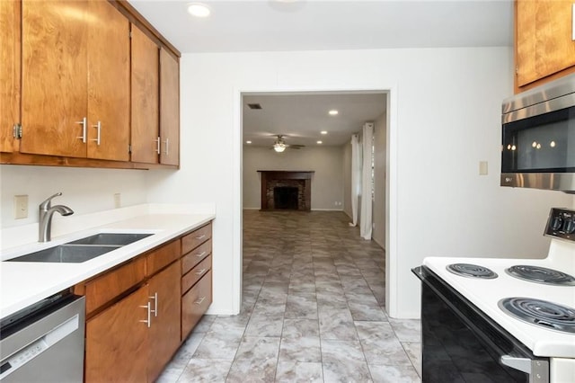 kitchen with ceiling fan, sink, and stainless steel appliances