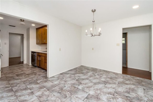 unfurnished dining area featuring a chandelier