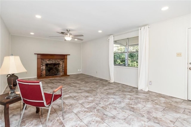 living room with ceiling fan and a fireplace