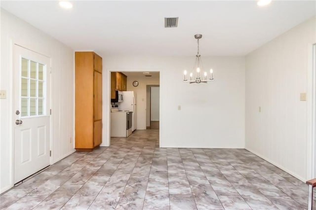 unfurnished dining area with a chandelier