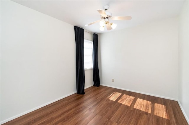 unfurnished room featuring ceiling fan and dark wood-type flooring