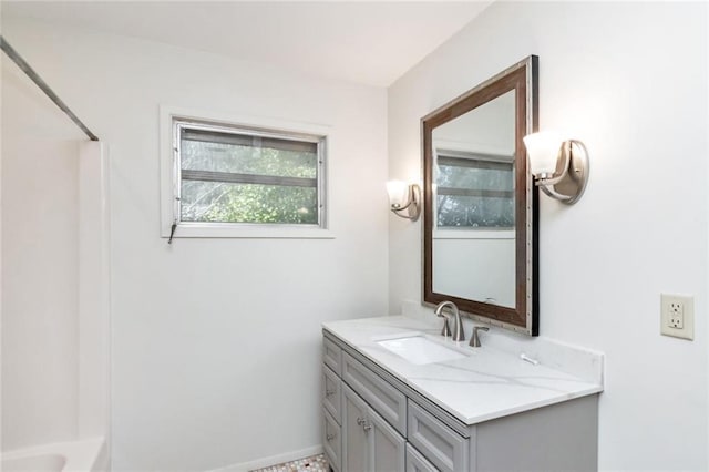 bathroom featuring vanity and  shower combination