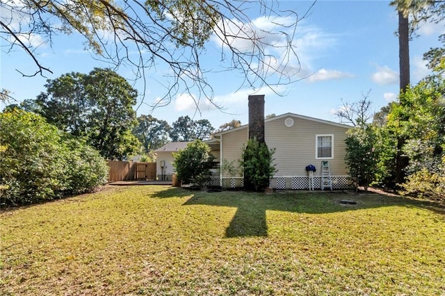 back of property featuring a lawn