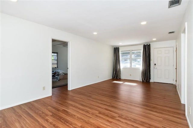 spare room with wood-type flooring