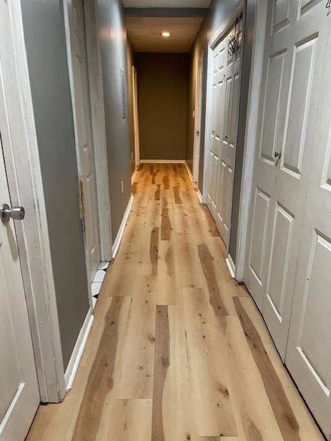 corridor with light hardwood / wood-style floors