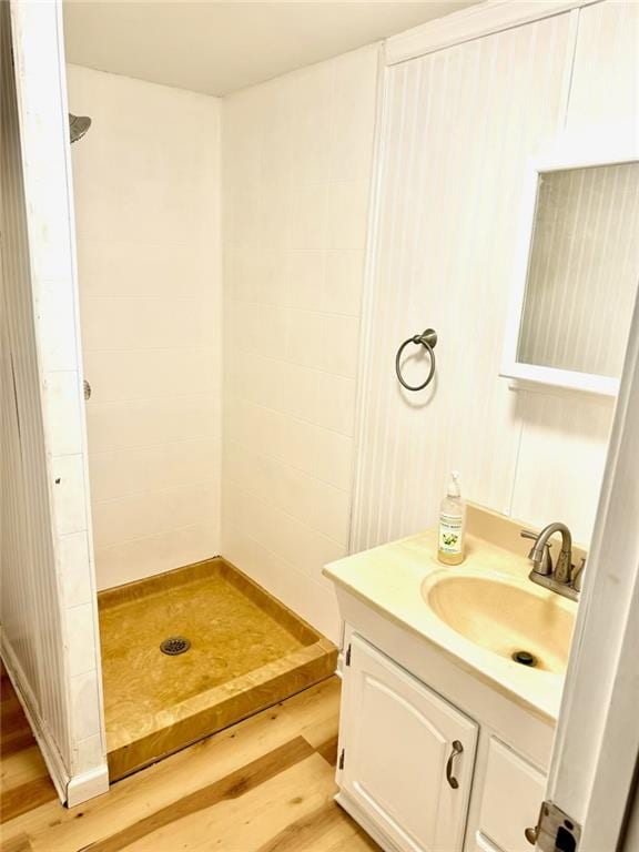 bathroom with vanity, wood-type flooring, and walk in shower