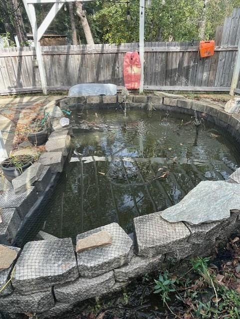 view of pool featuring a small pond